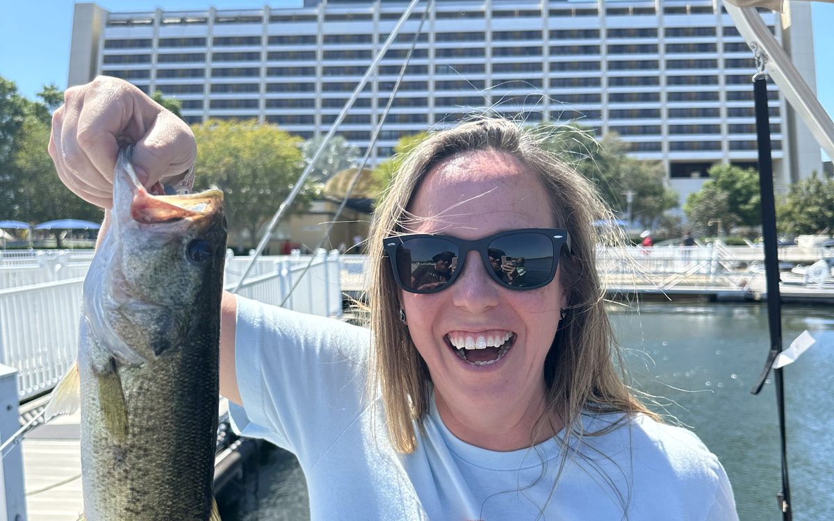 Lynne holding a bass caught on a Bay Lake fishing excursion