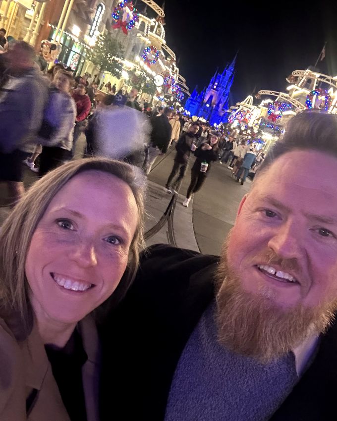 Lynne and her husband on Main Street U.S.A. at night
